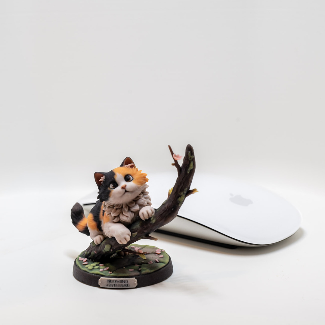 Full-color cat adventurer print next to a computer mouse for scale