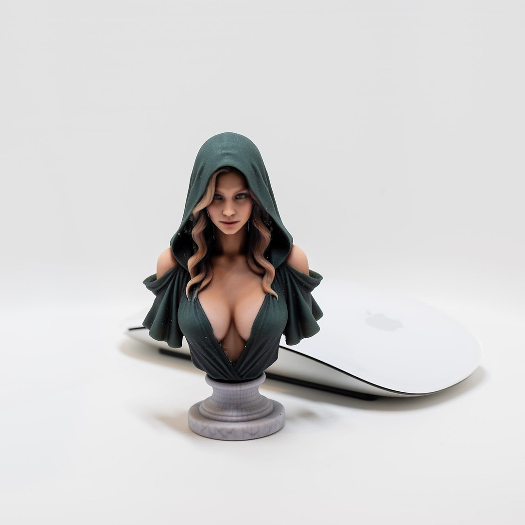 Full-color fantasy character bust next to a computer mouse for scale