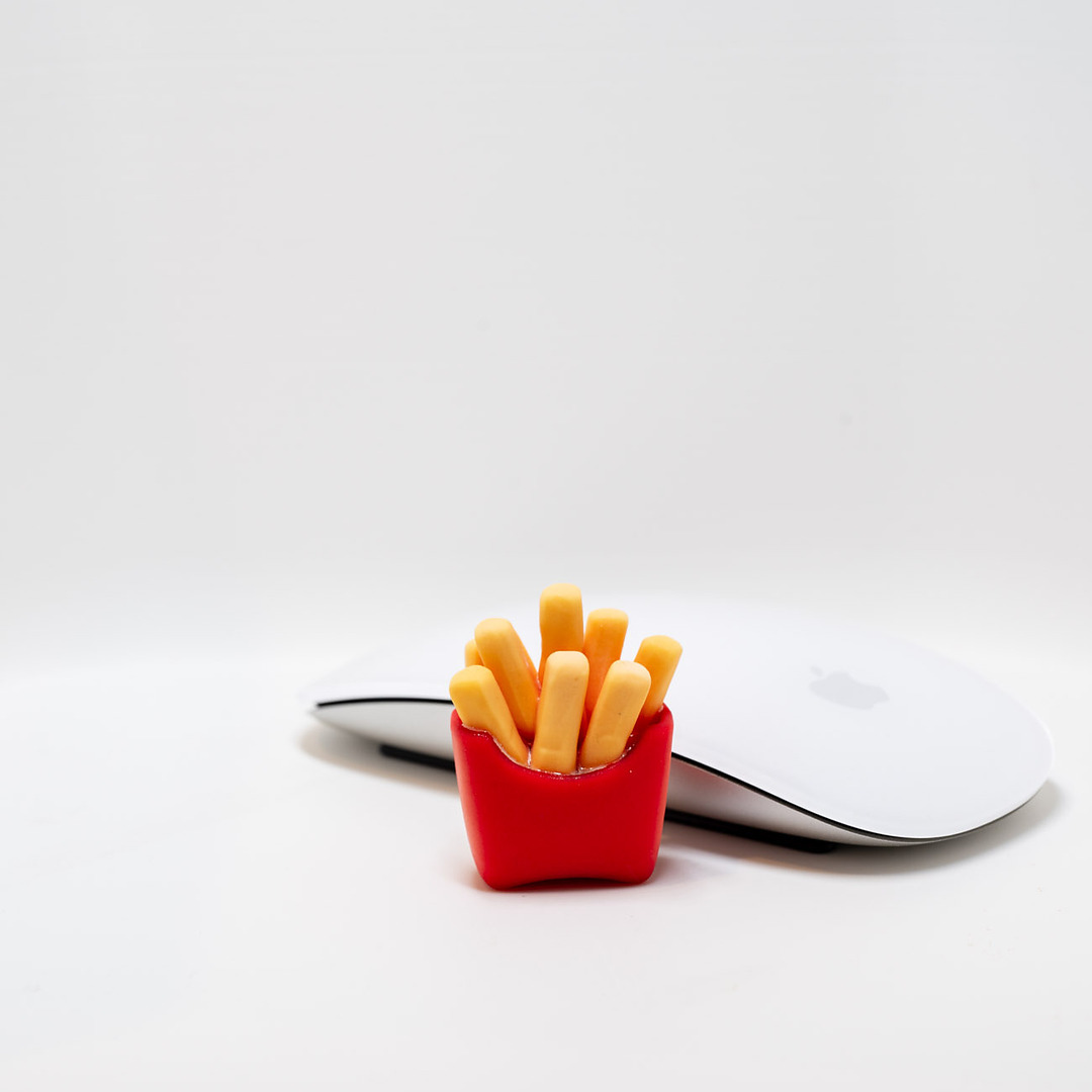 Full-color carton of french fries print next to a computer mouse for scale